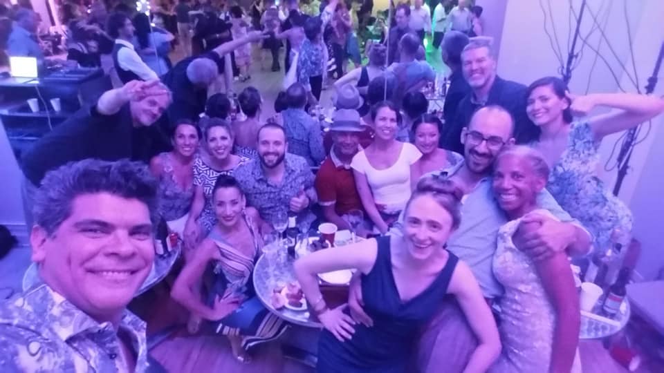 A large group of smiling 312 Tango dancers taking a selfie at a milonga in Chicago
